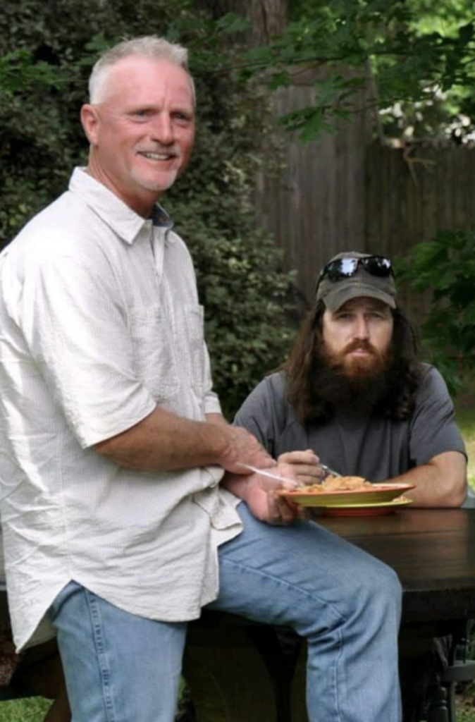 Jase Robertson and Jimmy Hatfield break bread over a new table from Hatfield Table Company